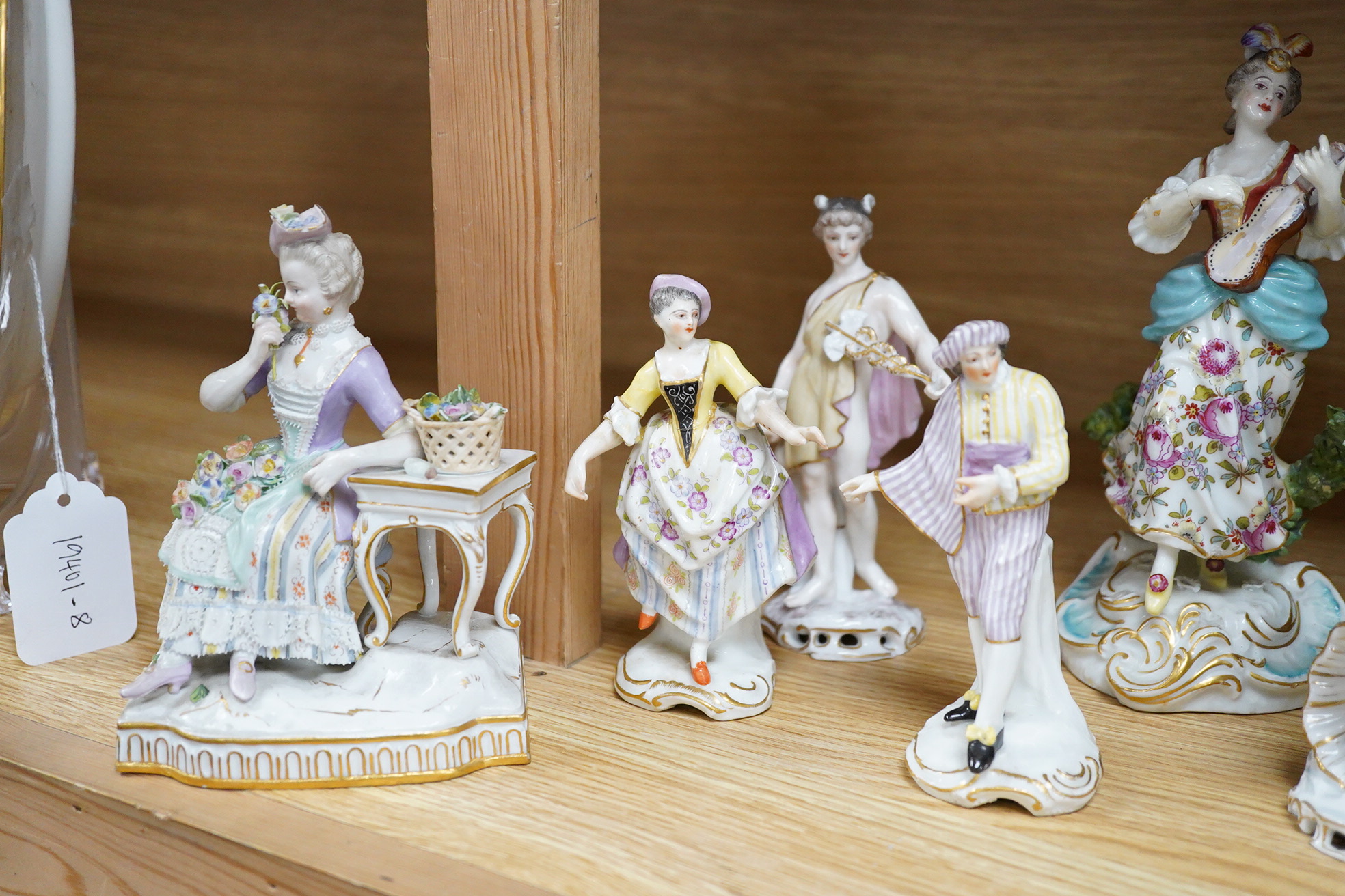 A Meissen seated figure emblematic of sense of smell, and three pairs of Continental porcelain figures, (7) tallest 19cm.